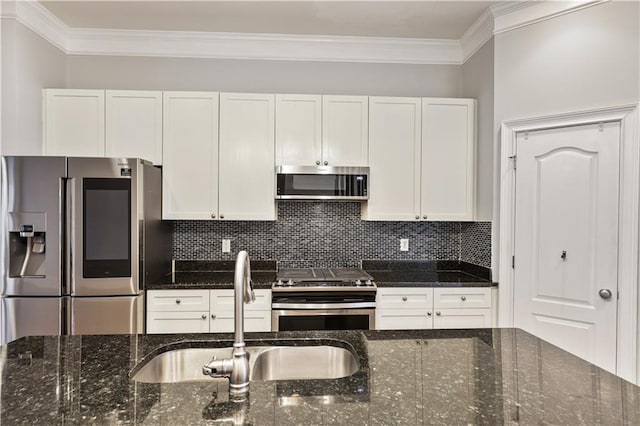 kitchen featuring appliances with stainless steel finishes, decorative backsplash, a sink, and ornamental molding