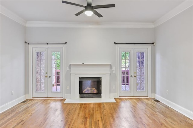 unfurnished living room with french doors, plenty of natural light, and wood finished floors