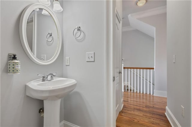 bathroom with baseboards and wood finished floors