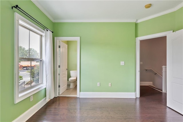 unfurnished bedroom featuring crown molding, baseboards, and wood finished floors