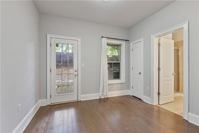 doorway to outside featuring a healthy amount of sunlight, baseboards, and wood finished floors