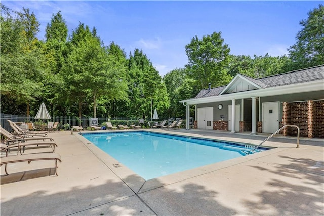 community pool featuring a patio area and fence