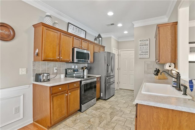 kitchen with light countertops, visible vents, stainless steel appliances, a sink, and brown cabinetry