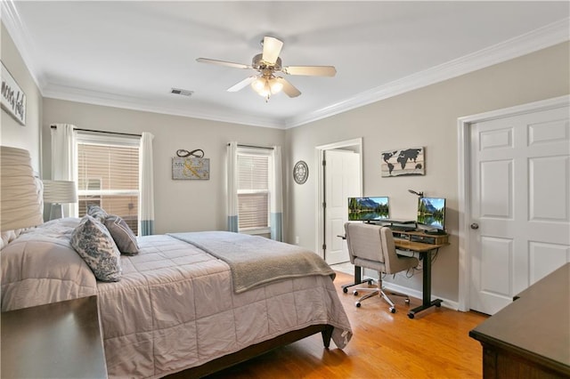bedroom with light wood-type flooring, crown molding, multiple windows, and visible vents