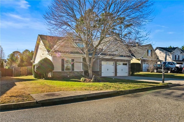 view of front of property with a garage, fence, concrete driveway, and a front yard