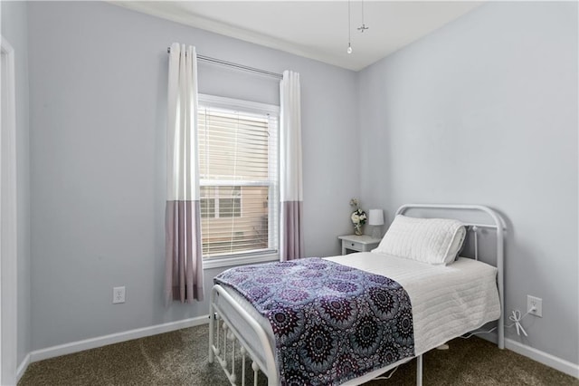 bedroom featuring baseboards and dark carpet