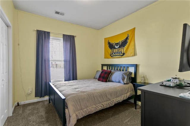 carpeted bedroom featuring baseboards and visible vents
