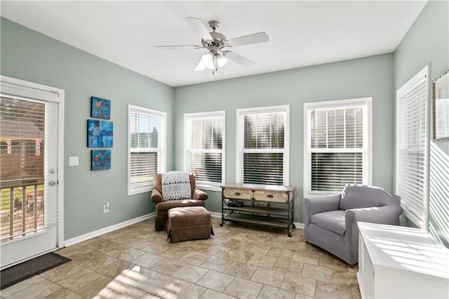 sitting room with baseboards and a ceiling fan
