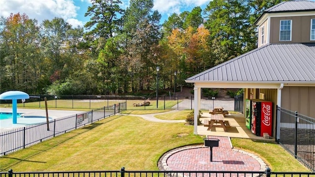 view of home's community with a patio area, a lawn, and fence