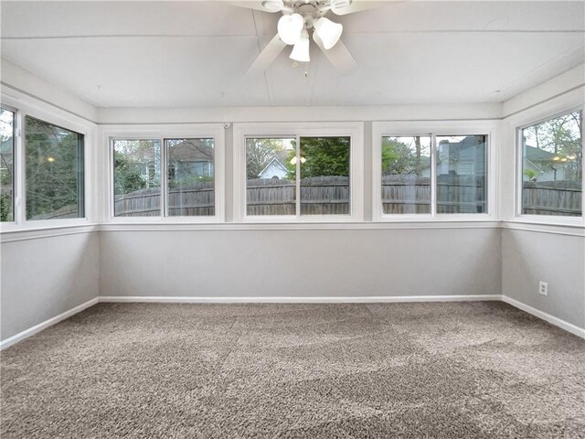 unfurnished living room featuring built in shelves, light hardwood / wood-style flooring, a healthy amount of sunlight, and ornamental molding