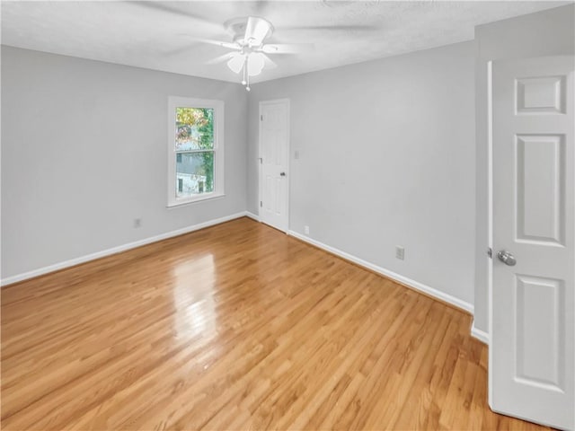 unfurnished room with light hardwood / wood-style floors and ceiling fan