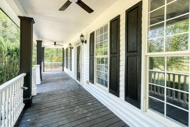 wooden deck with ceiling fan and a porch