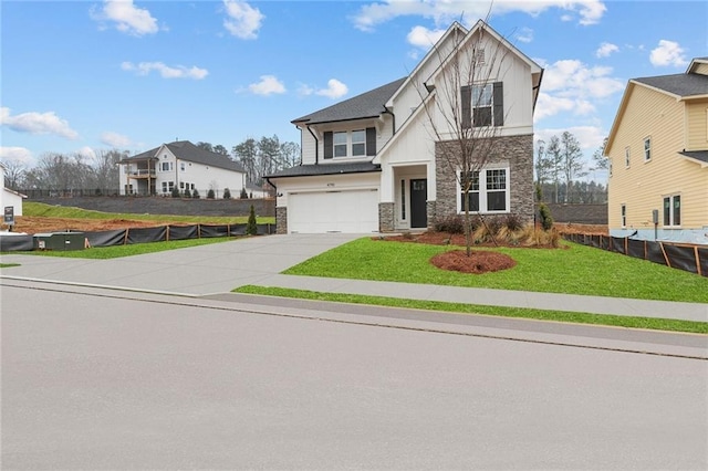 view of front of house with a garage and a front yard