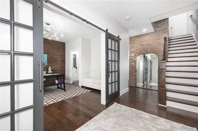 410 Concord St, Alpharetta, GA 30009 - entryway featuring a barn door, stairs, wood finished floors, baseboards, and wood walls