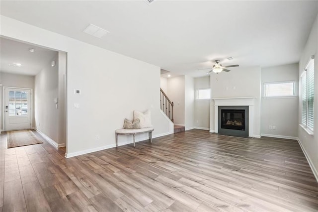 unfurnished living room with light hardwood / wood-style floors and ceiling fan