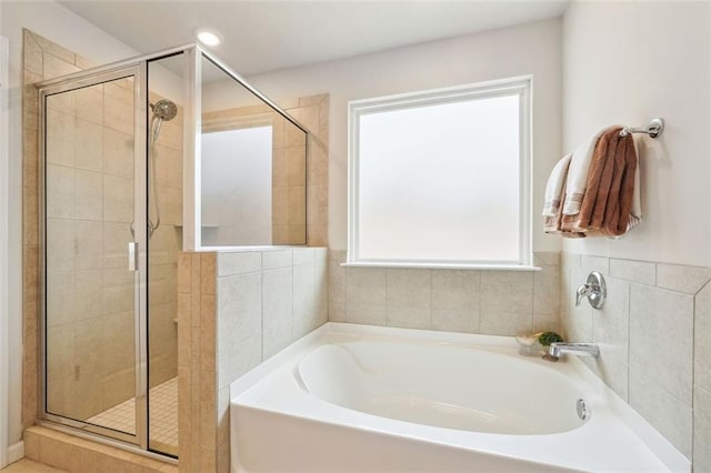 bathroom with shower with separate bathtub