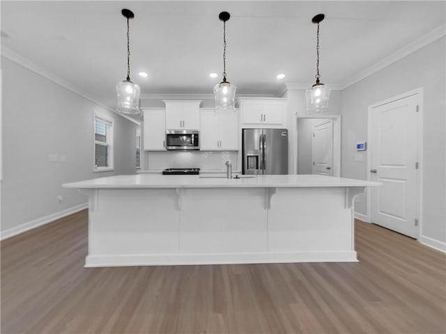 kitchen featuring stainless steel appliances, white cabinetry, ornamental molding, and light countertops