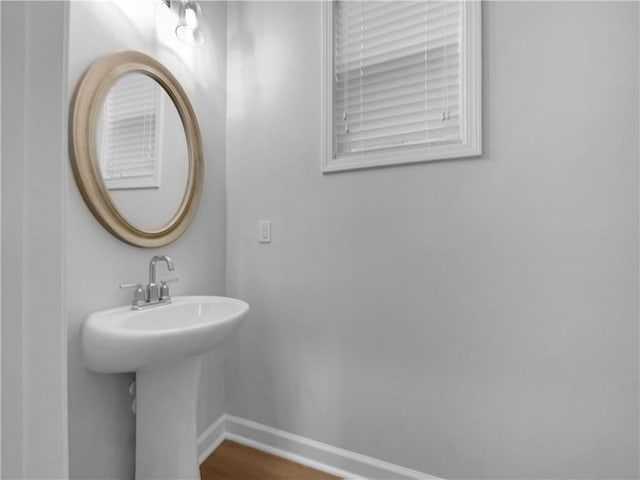 bathroom with a sink and baseboards