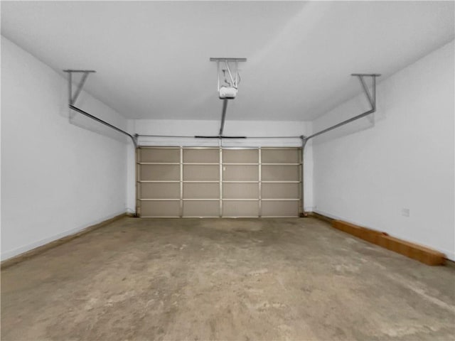 garage with baseboards and a garage door opener