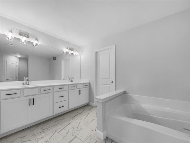 full bathroom with a sink, a garden tub, marble finish floor, and double vanity