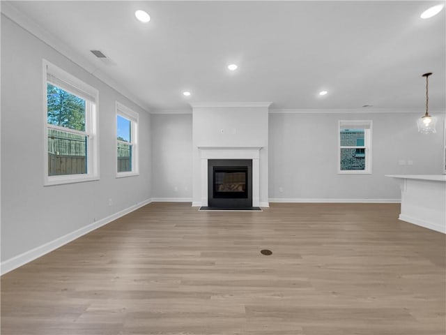 unfurnished living room featuring a fireplace with flush hearth, baseboards, light wood-style flooring, and crown molding