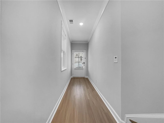 hall with visible vents, baseboards, ornamental molding, recessed lighting, and wood finished floors