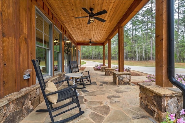 view of patio featuring ceiling fan and a porch