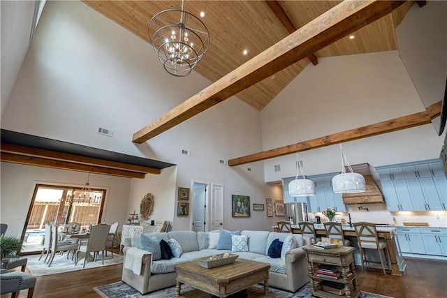 living room with high vaulted ceiling, dark hardwood / wood-style floors, and a chandelier