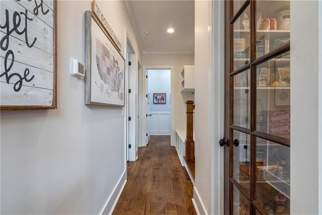 hall with ornamental molding and dark hardwood / wood-style flooring