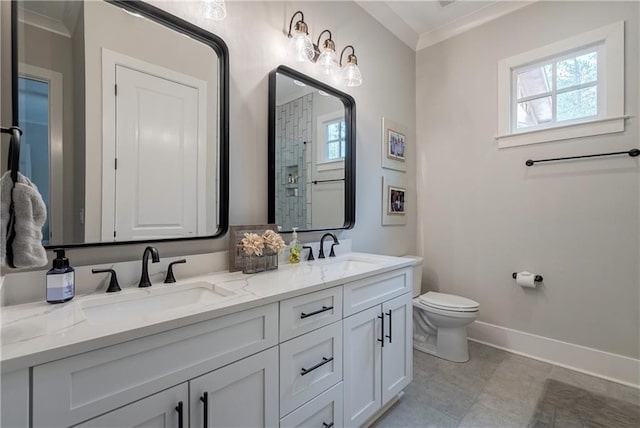 bathroom with vanity, toilet, and ornamental molding