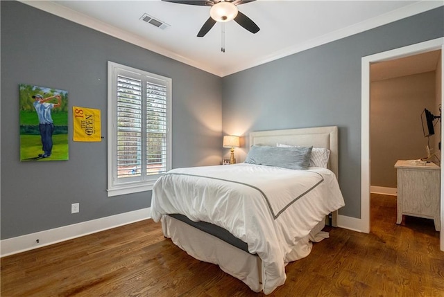 bedroom with ceiling fan, ornamental molding, and dark wood-type flooring