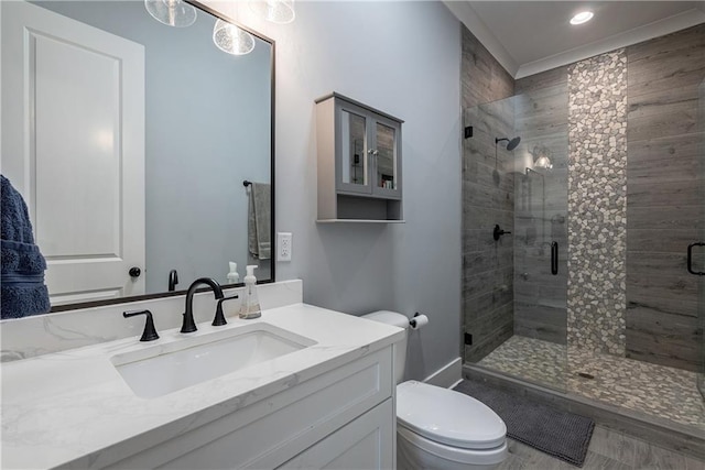 bathroom with toilet, walk in shower, and vanity