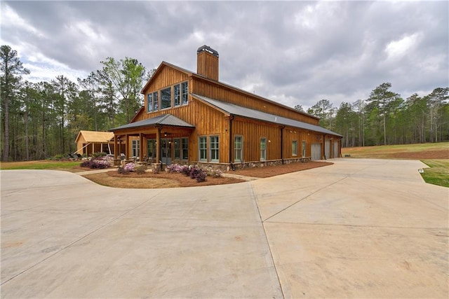 view of side of home with a garage and covered porch