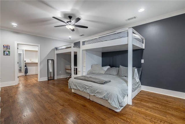 bedroom with ceiling fan, dark wood-type flooring, and ornamental molding