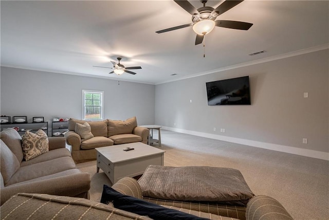 living room with ceiling fan, ornamental molding, and light carpet