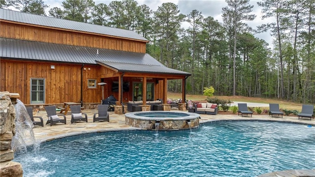 view of swimming pool featuring pool water feature, an in ground hot tub, and a patio area