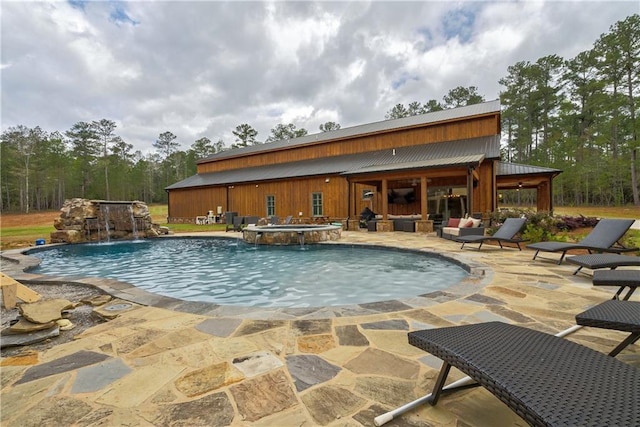 view of swimming pool featuring an in ground hot tub, a patio area, and pool water feature