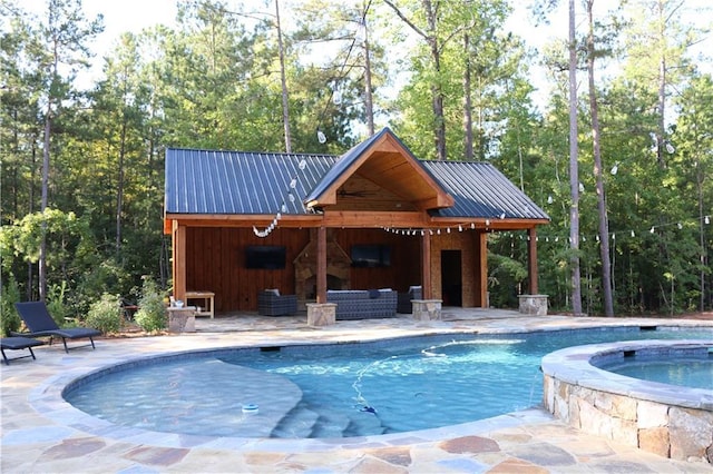 view of swimming pool with an in ground hot tub, outdoor lounge area, and a patio area