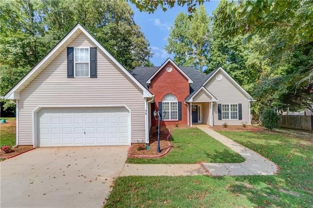 traditional home featuring brick siding, fence, a garage, driveway, and a front lawn