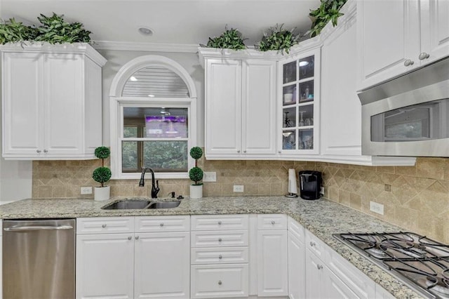 kitchen featuring appliances with stainless steel finishes, tasteful backsplash, and white cabinets