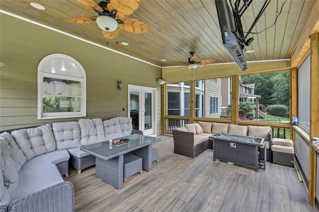 sunroom / solarium featuring french doors, wood ceiling, and ceiling fan