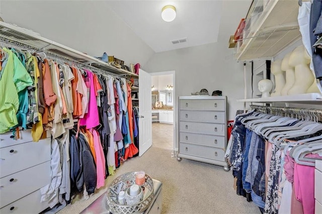 spacious closet featuring light carpet