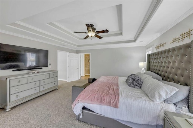 carpeted bedroom with ceiling fan, ornamental molding, and a raised ceiling