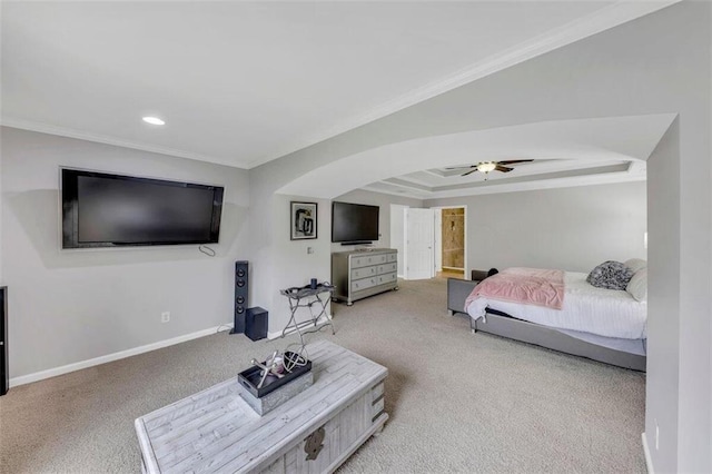 carpeted bedroom featuring a raised ceiling, crown molding, and ceiling fan