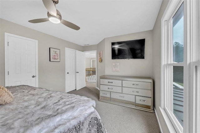 bedroom with dark colored carpet and ceiling fan