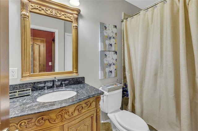 bathroom with toilet and vanity