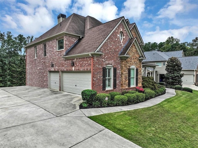 view of front of house with a front yard and a garage