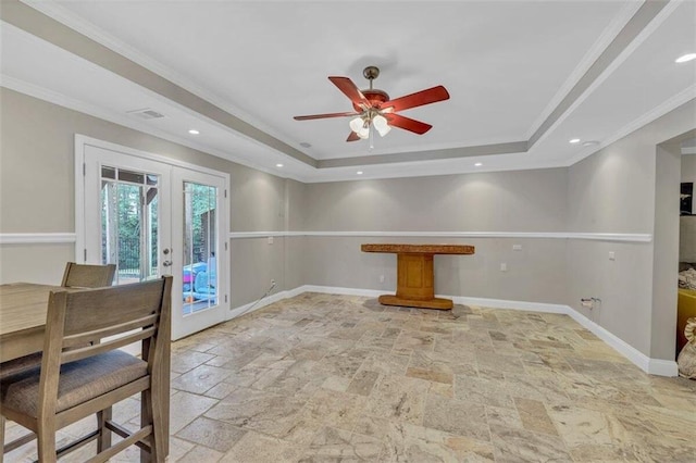 interior space featuring ceiling fan, crown molding, a tray ceiling, and french doors