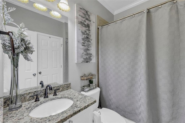 bathroom featuring vanity, toilet, and ornamental molding