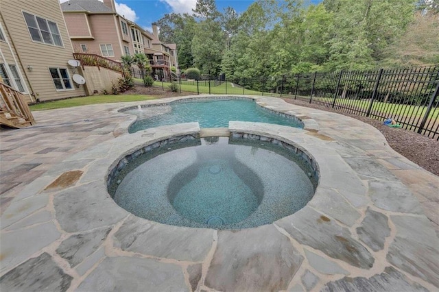 view of pool with a deck and an in ground hot tub